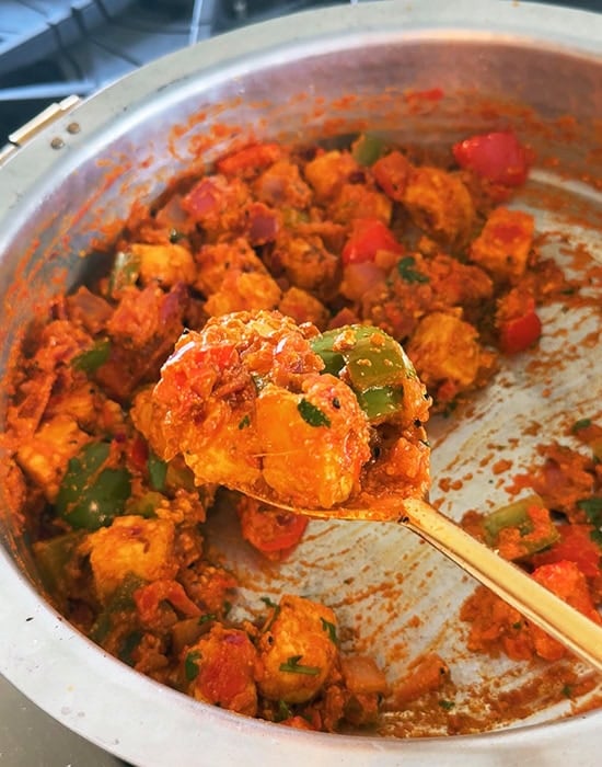 spatula showing mixed paneer and veggies