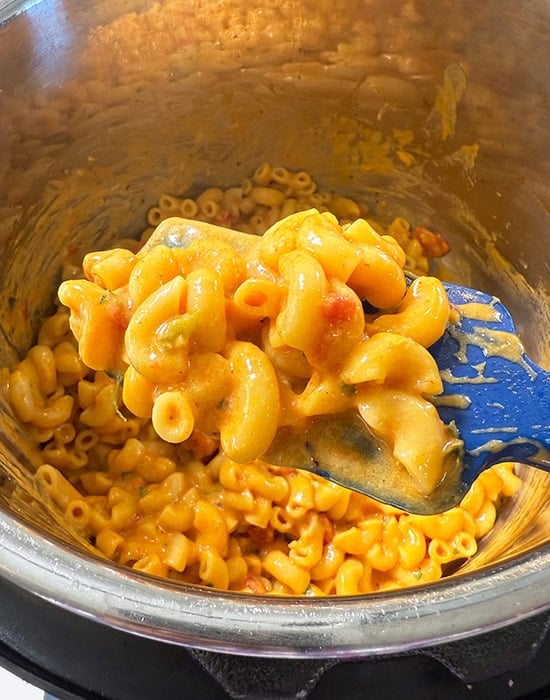 spatula showing cheesy pasta