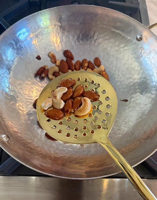 spatula showing fried nuts placed on it