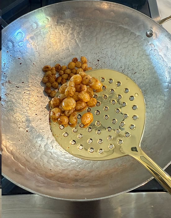 spatula showing fried plump raisins