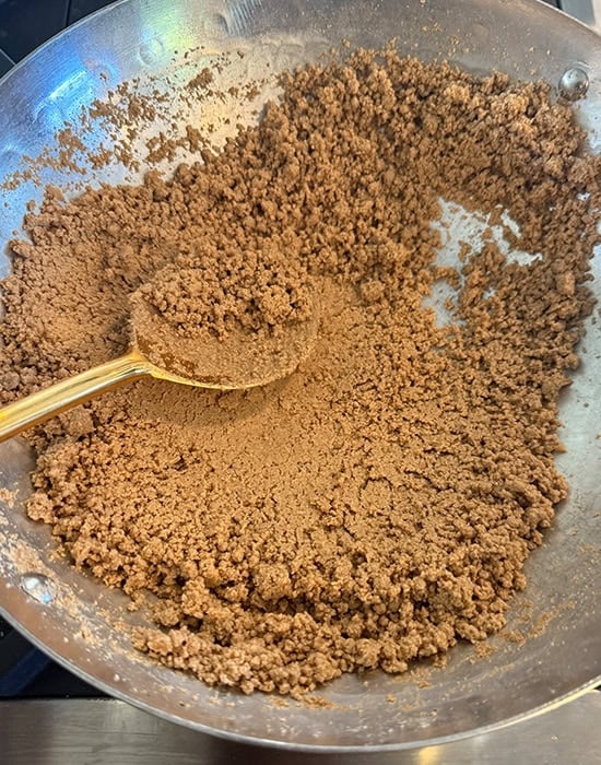 roasted dark brown color atta in a kadai