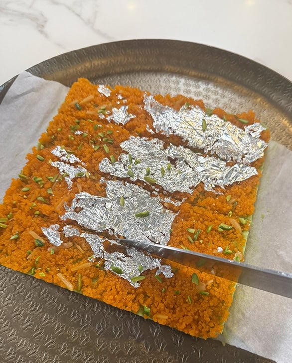 a knife cutting burfi itno slices