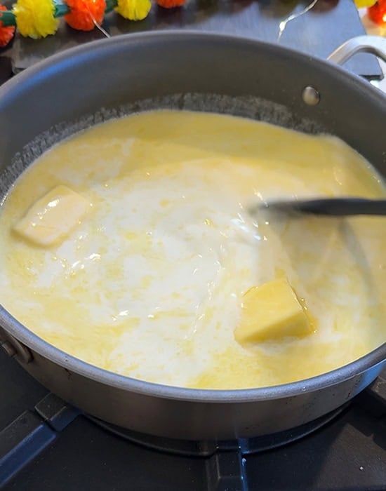 butter and milk melts in a pan