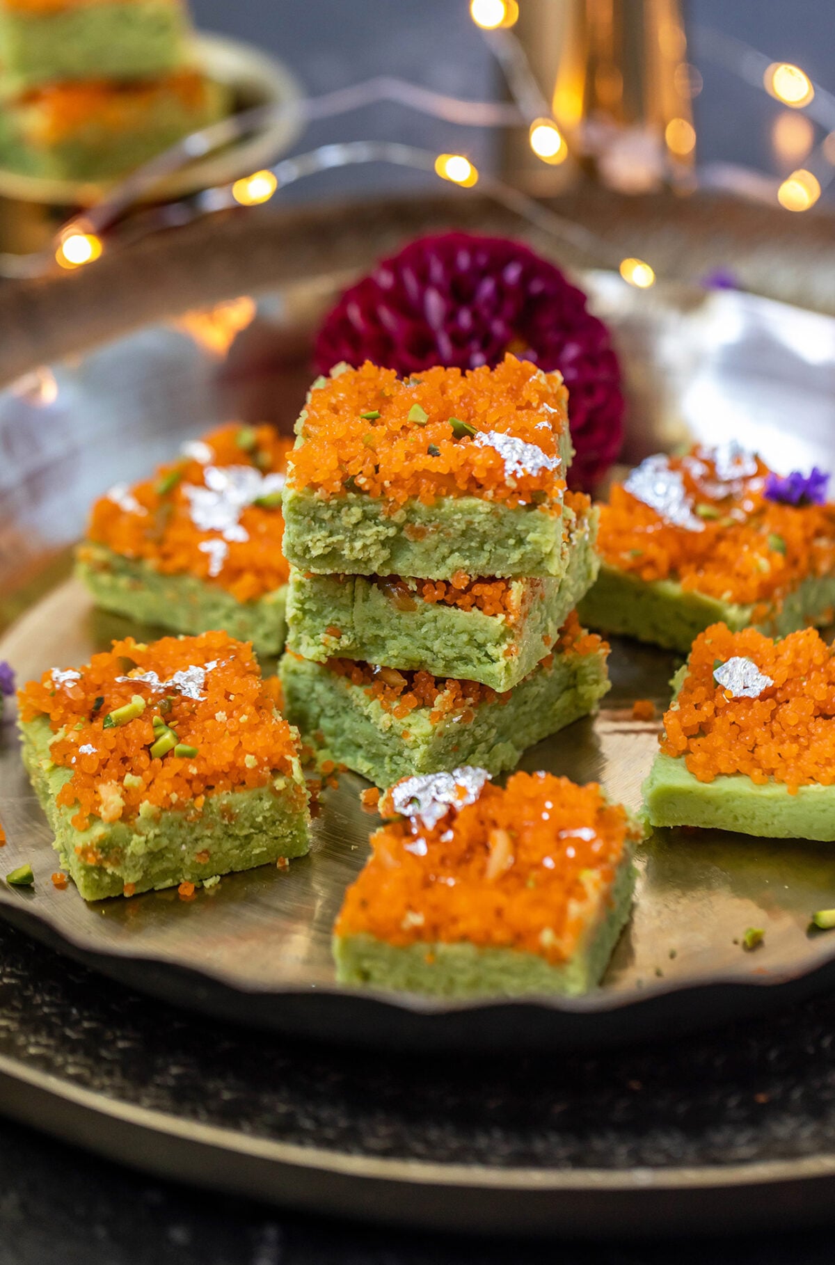 matcha burfis topped with motichoor stacked together