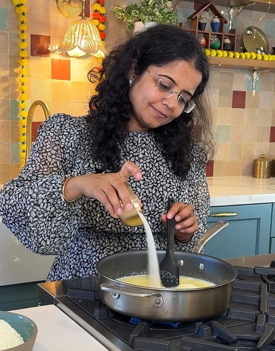 a woman pouring a bowl of sugar in a pan