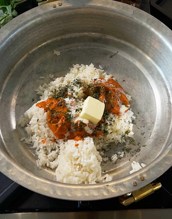 rice with butter, tomato sauce in pan