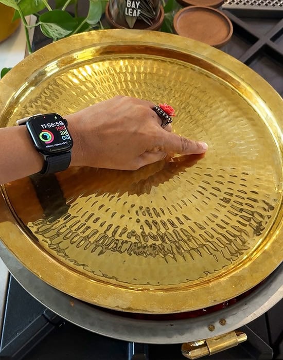 hand covering pot with a lid