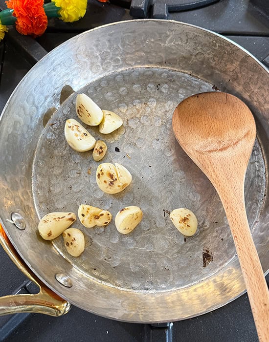 garlic being roasted in a pan