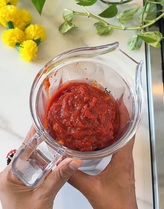 tomato with spices added to a blender