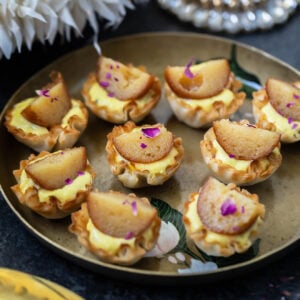 phyllo shells topped with gulab jamun arranged in an antique plate