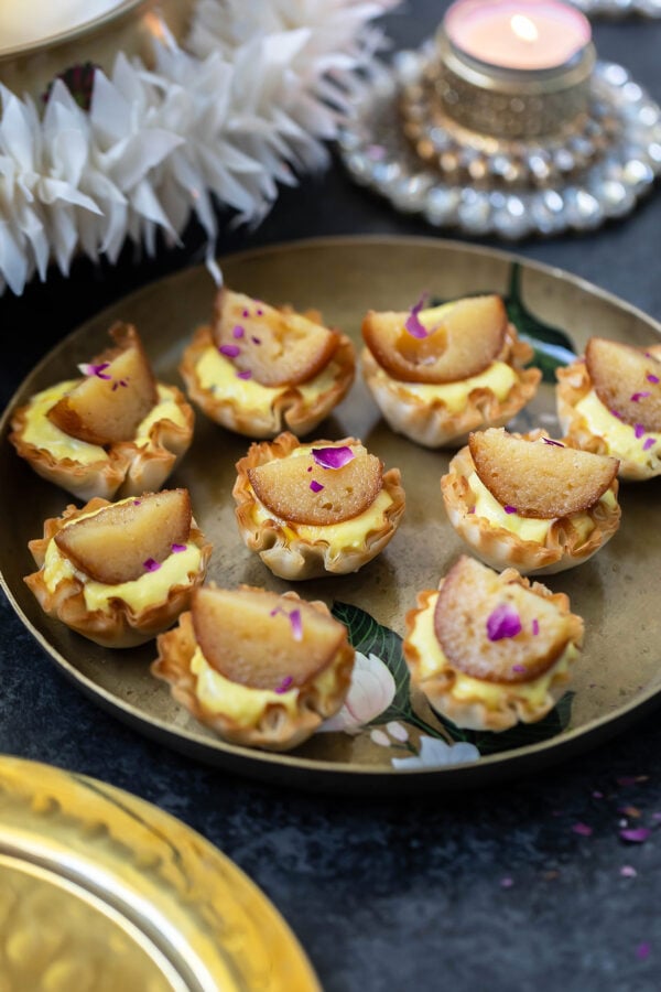 phyllo shells topped with gulab jamun arranged in an antique plate