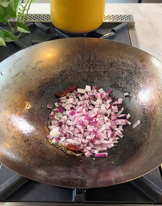 chopped onions in a wok