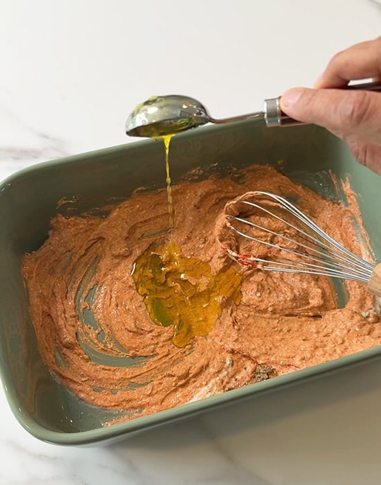 mustard oil being added to a marinade