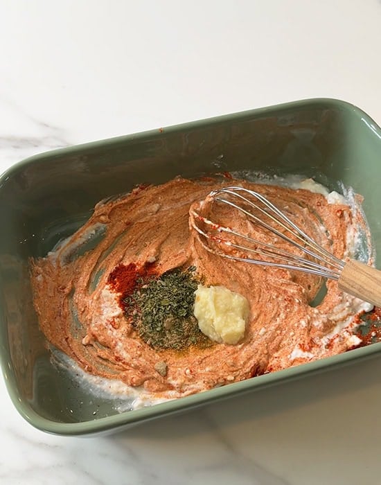 yogurt with spices, ginger garlic paste in a pan