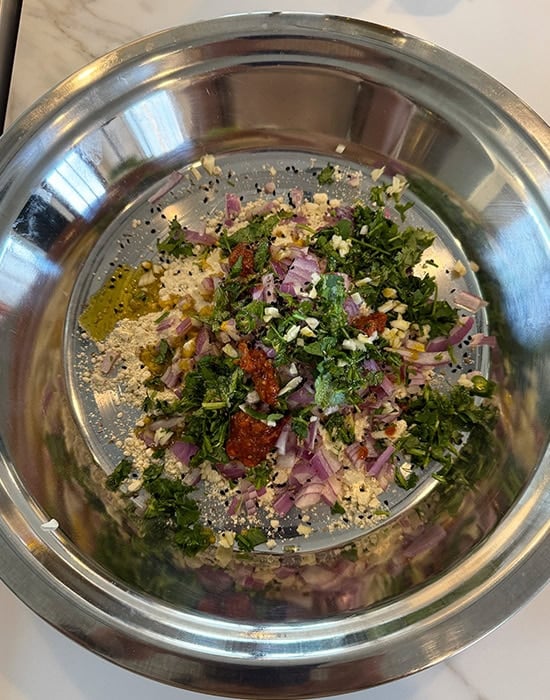 sattu with chopped onions, cilantro, chilies in a bowl