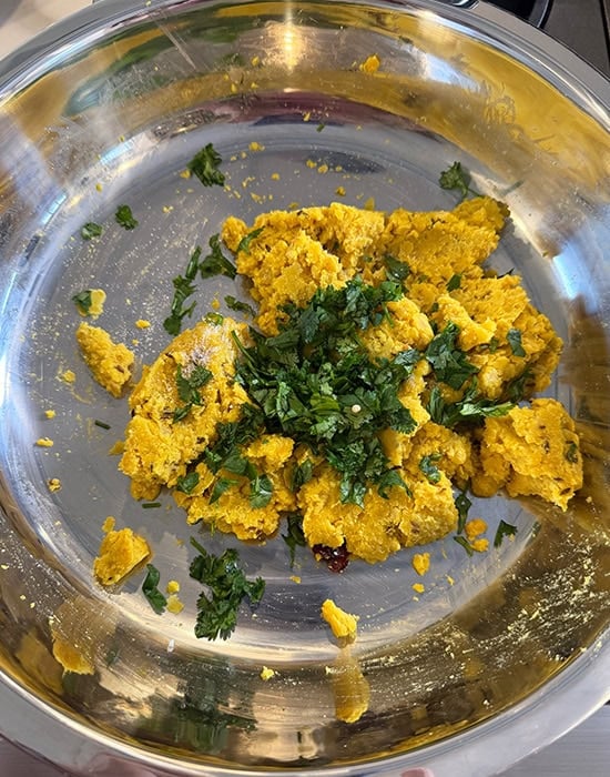 mashed dal with spices and chopped cilantro in a plate