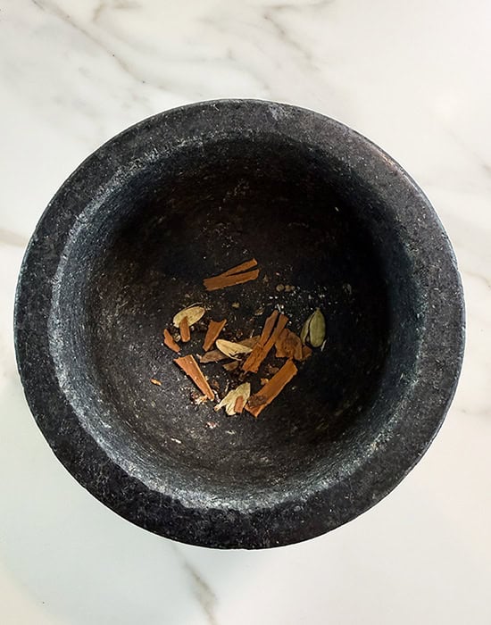 crushed whole spices in a mortar pestle