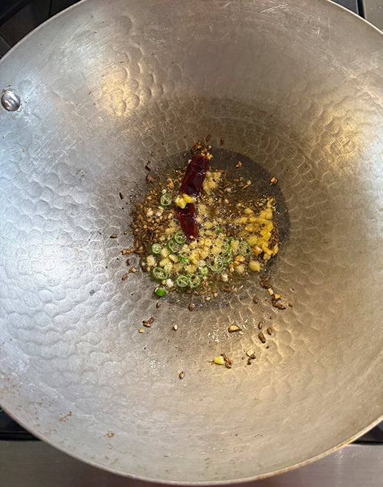 oil with garlic, chilies in a kadai