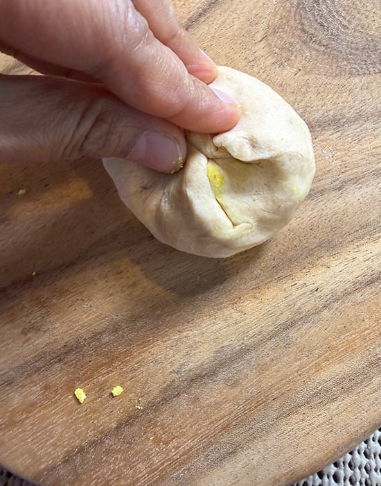 hand sealing the dough by pinching it from the sides