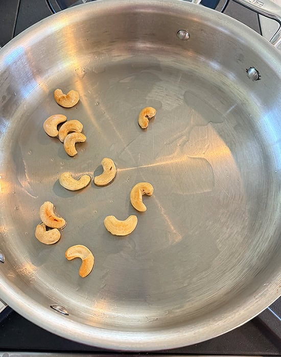 cashews being roasted in pan