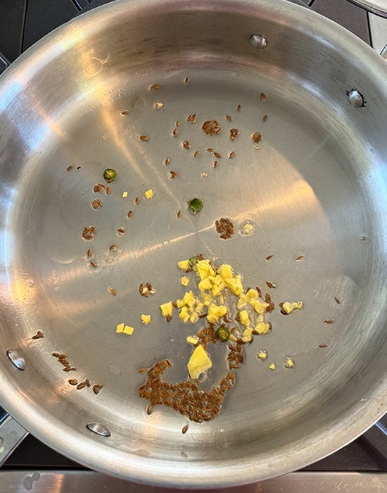 cumin ginger sauteed in a steel pan