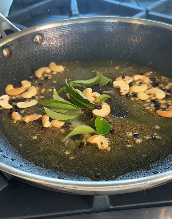 curry leaves with spices in a pan