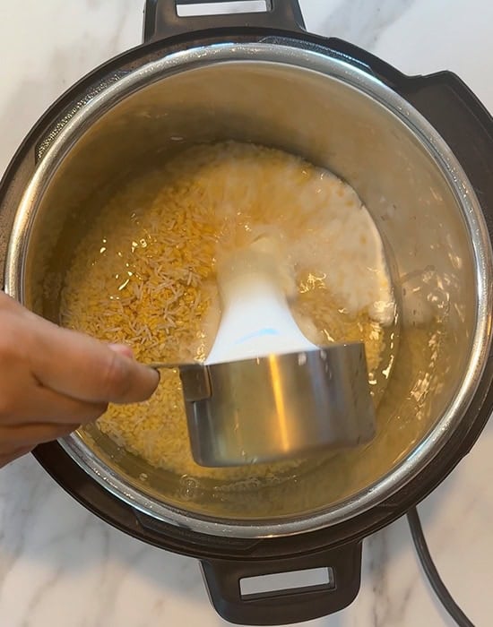 water milk added to pot of rice dal