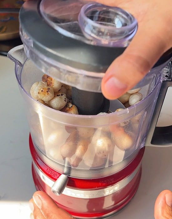 adding makhana to a food processor