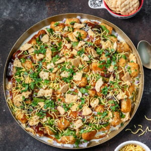 overhead shot of tater tots topped with chutneys, yogurt