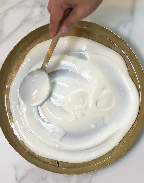 a spoon spreading yogurt in a plate