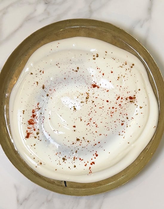 spices sprinkled on a plate of yogurt