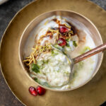 rasgulla chaat topped with pomegranate served in a copper bowl