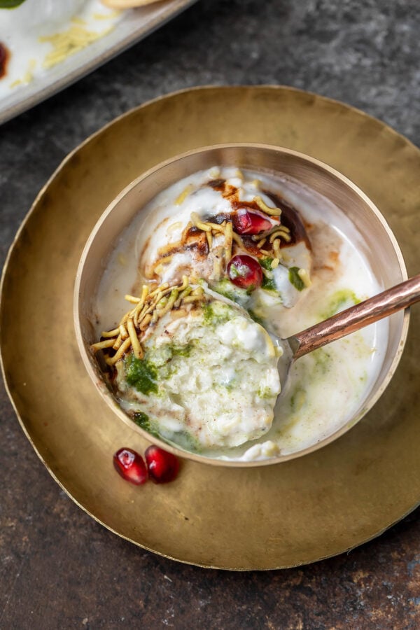 rasgulla chaat topped with pomegranate served in a copper bowl