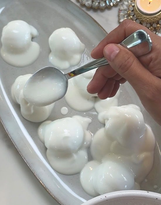 adding yogurt on top of rasgulla