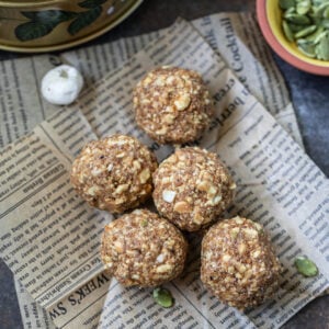 five sattu ladoos arranged on top of a newspaper cutting