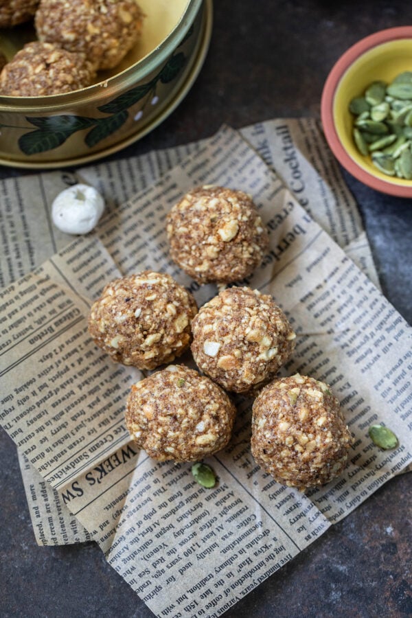 five sattu ladoos arranged on top of a newspaper cutting