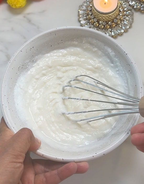 yogurt being whisk with a wire whisk